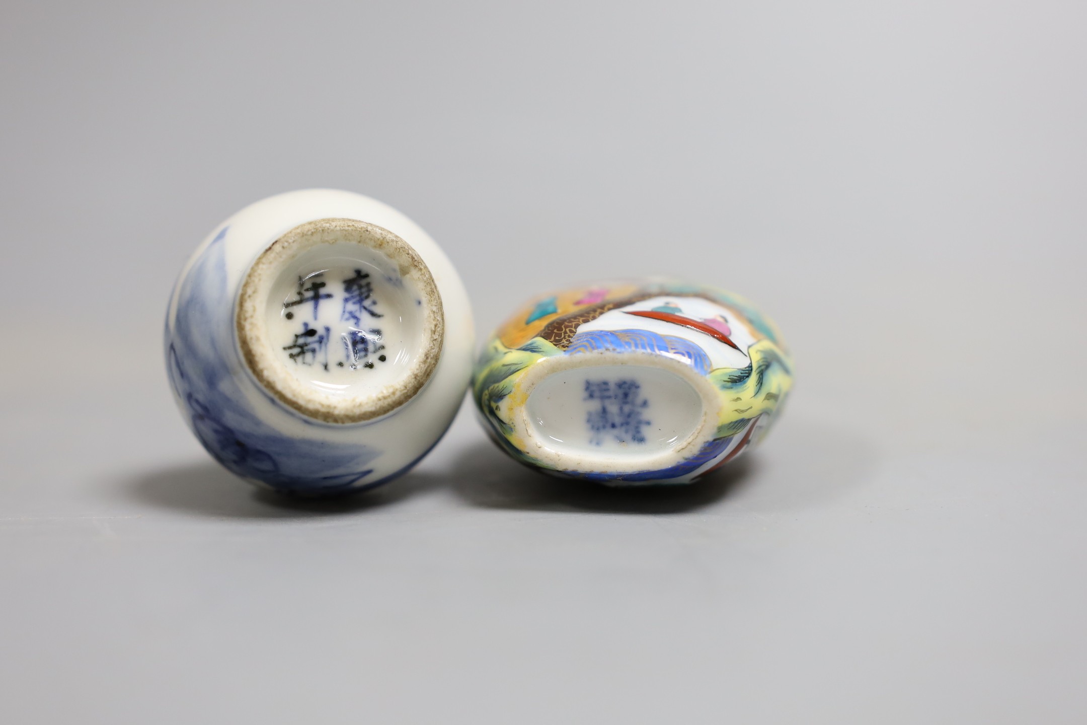 Two Chinese snuff bottles, to include a blue and white c.1900 bottle, and a famille rose bottle with stopper, largest 8.5cm long, (2)